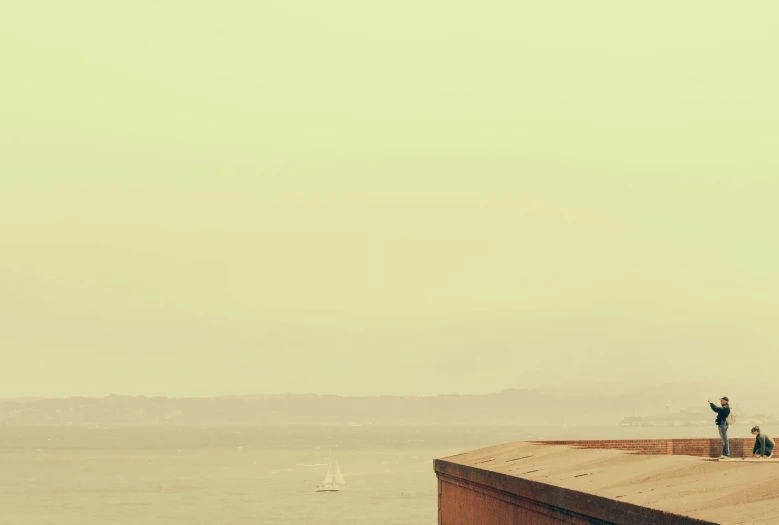 two people looking out on the ocean while standing