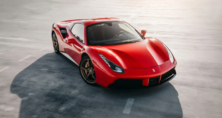 an all red sports car in a parking lot