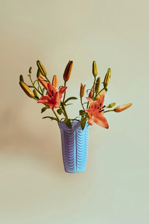 an arrangement of flowers in a blue vase