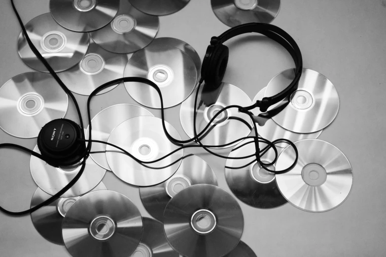 many cds are grouped together with headphones in them