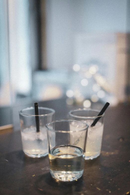 a couple of glasses with some black straws