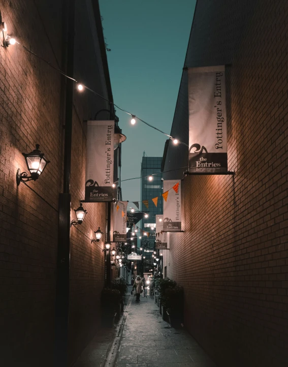 people are walking down a dark city street