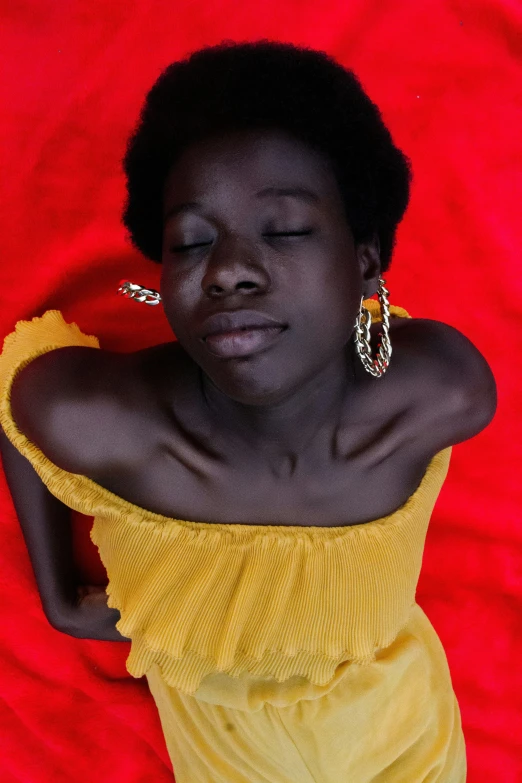 a woman with earrings laying down