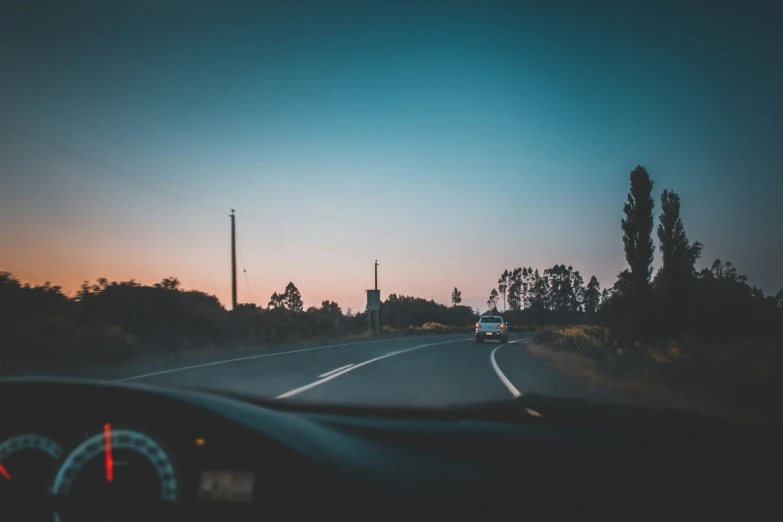 the dashboard of a car is seen at dusk