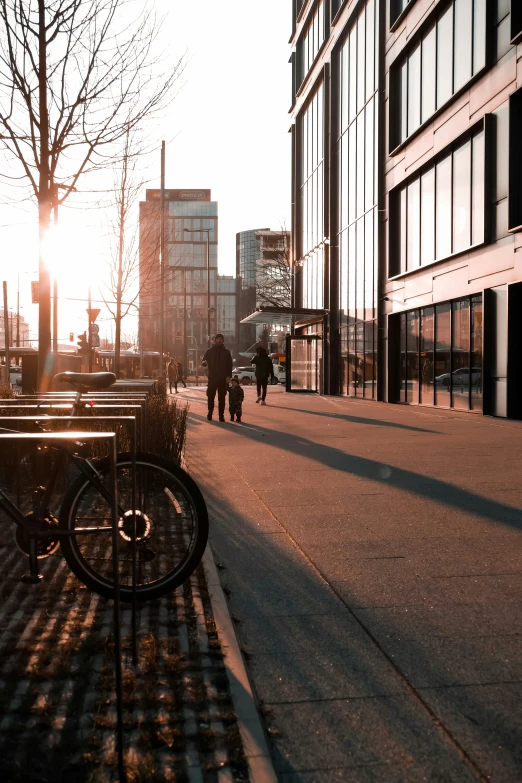 people walking down the sidewalk near the city