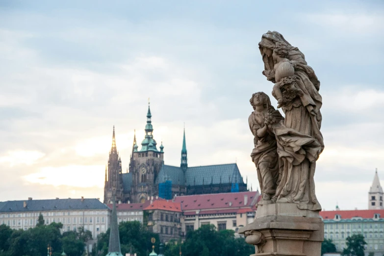 statue with city in the background behind it