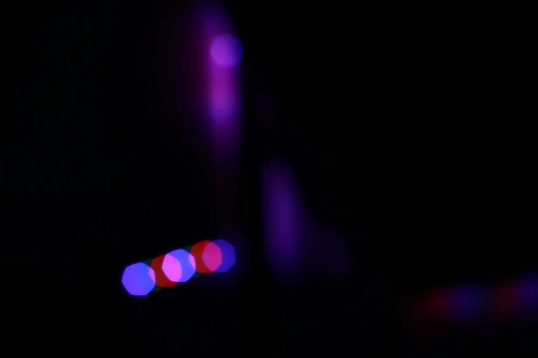 purple lights at night shining in dark room