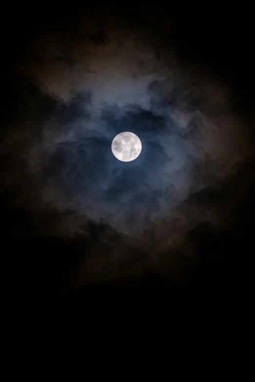 the moon is shining bright against a cloud