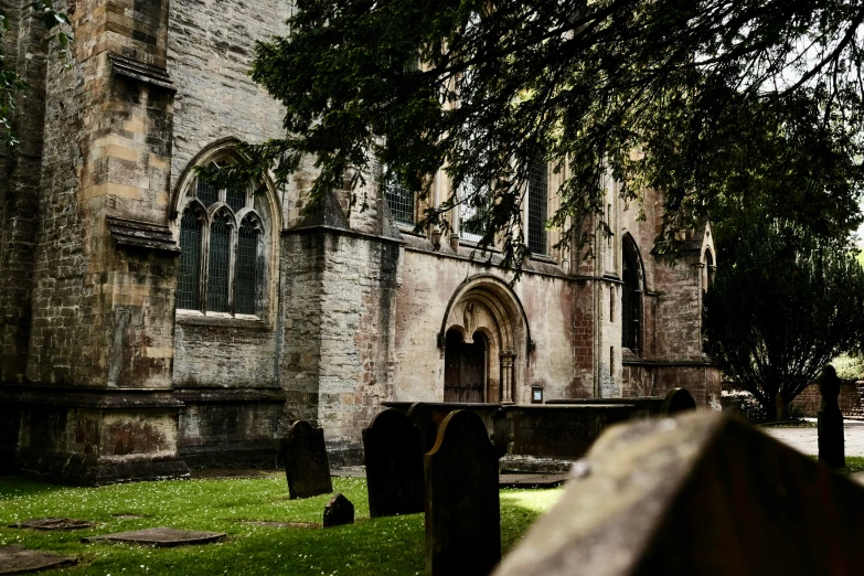 a cemetery on the side of a large stone building