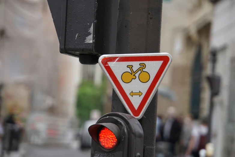 a traffic light and warning sign on a post