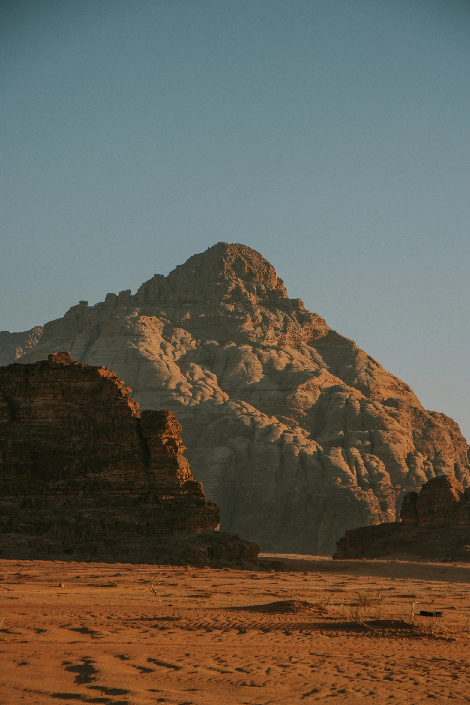 a rocky mountain side covered in sand