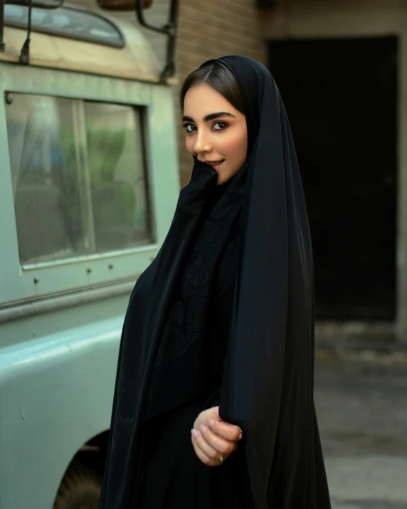 a girl in a black robe poses for a pograph