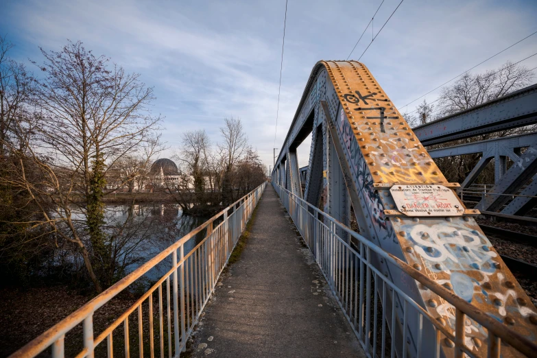 a bridge with graffiti and a bridge with no cars above it