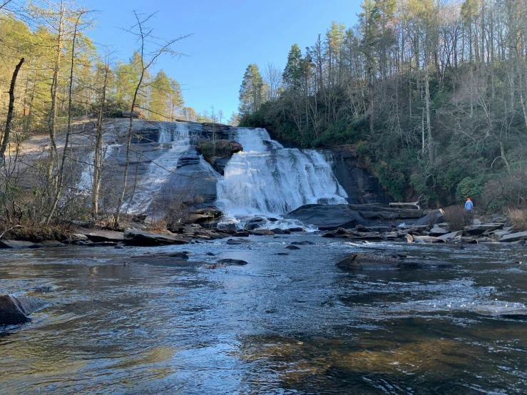 a view of a large waterfall with people below