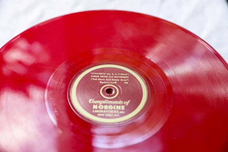 a close up s of a record playing on a red vinyl