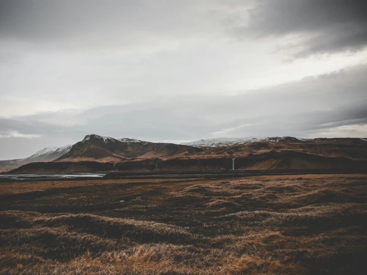 a train is passing by on a dark, cloudy day