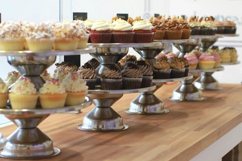 a close up view of various cupcakes on trays