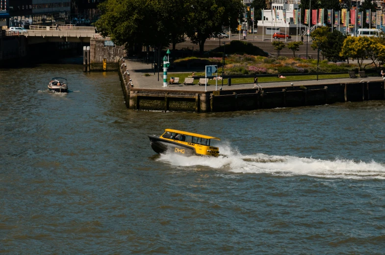 a yellow boat driving through a body of water