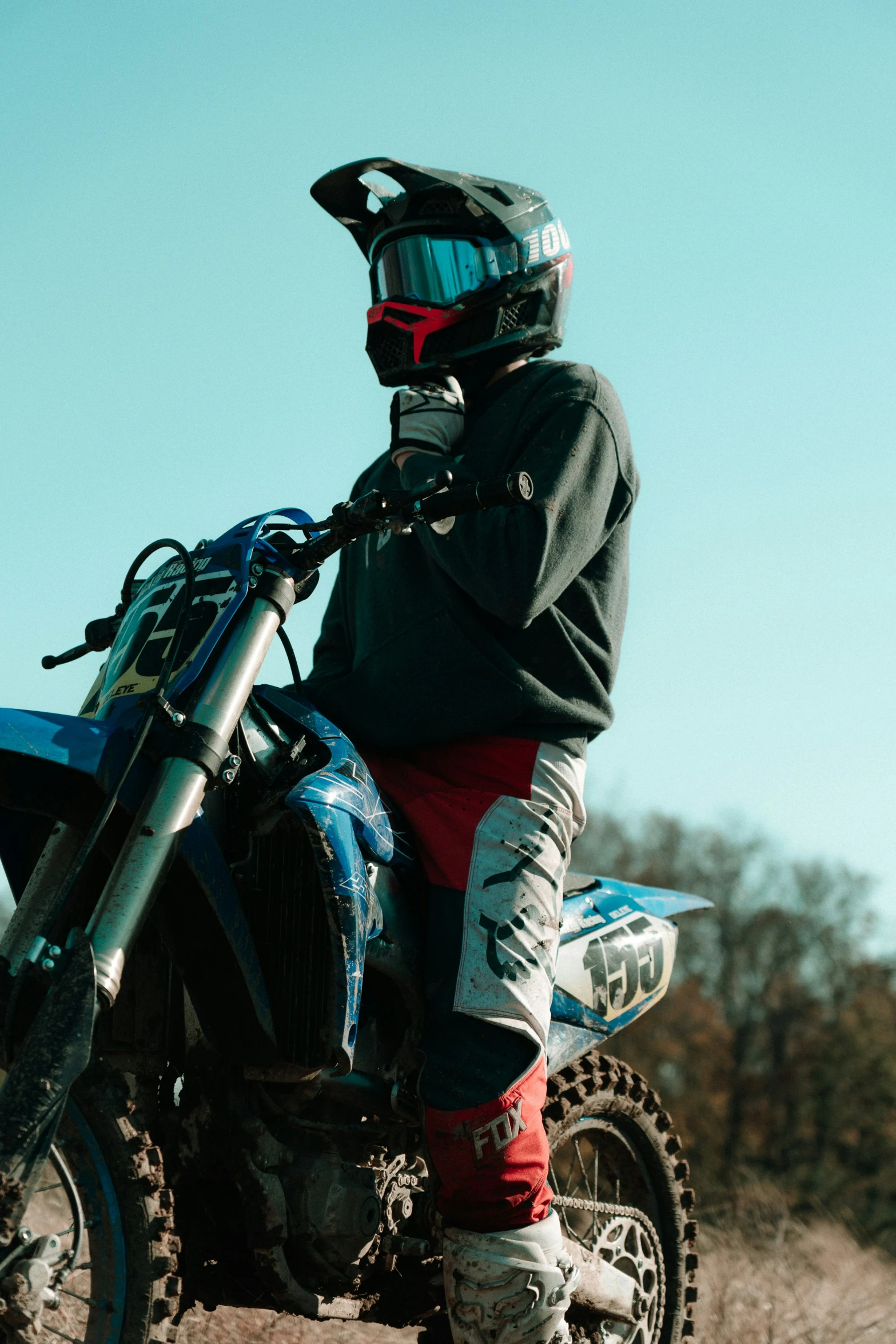 a person with a helmet sits on their dirt bike