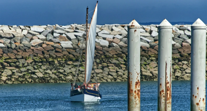 a boat out on the water in front of several posts