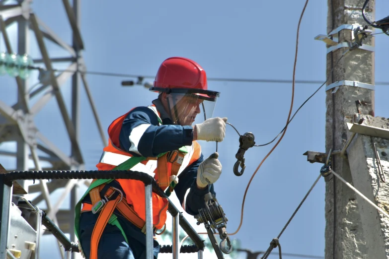 an electric worker with safety clothing and gloves