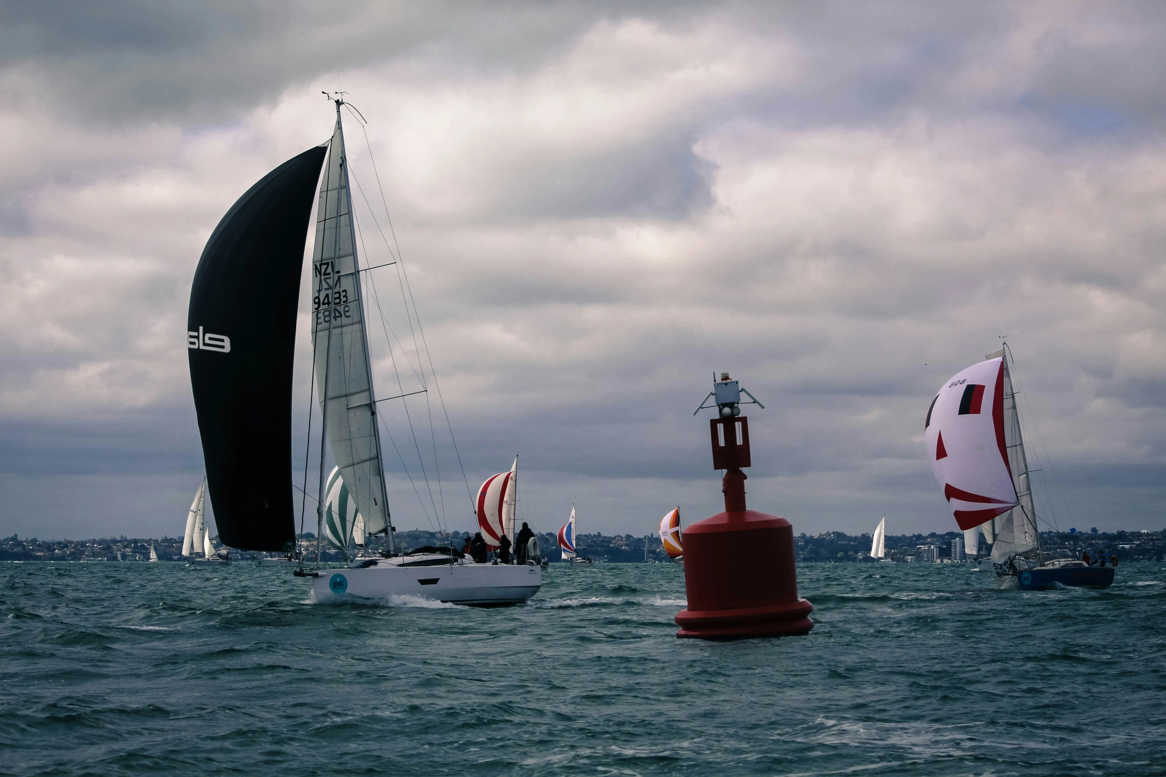 a group of sailboats riding on the water