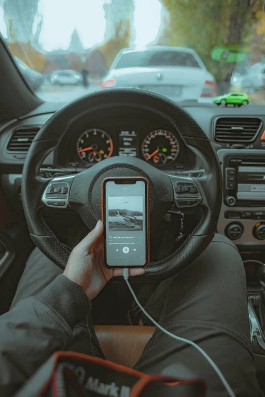 someone is sitting in the passenger seat using a cell phone