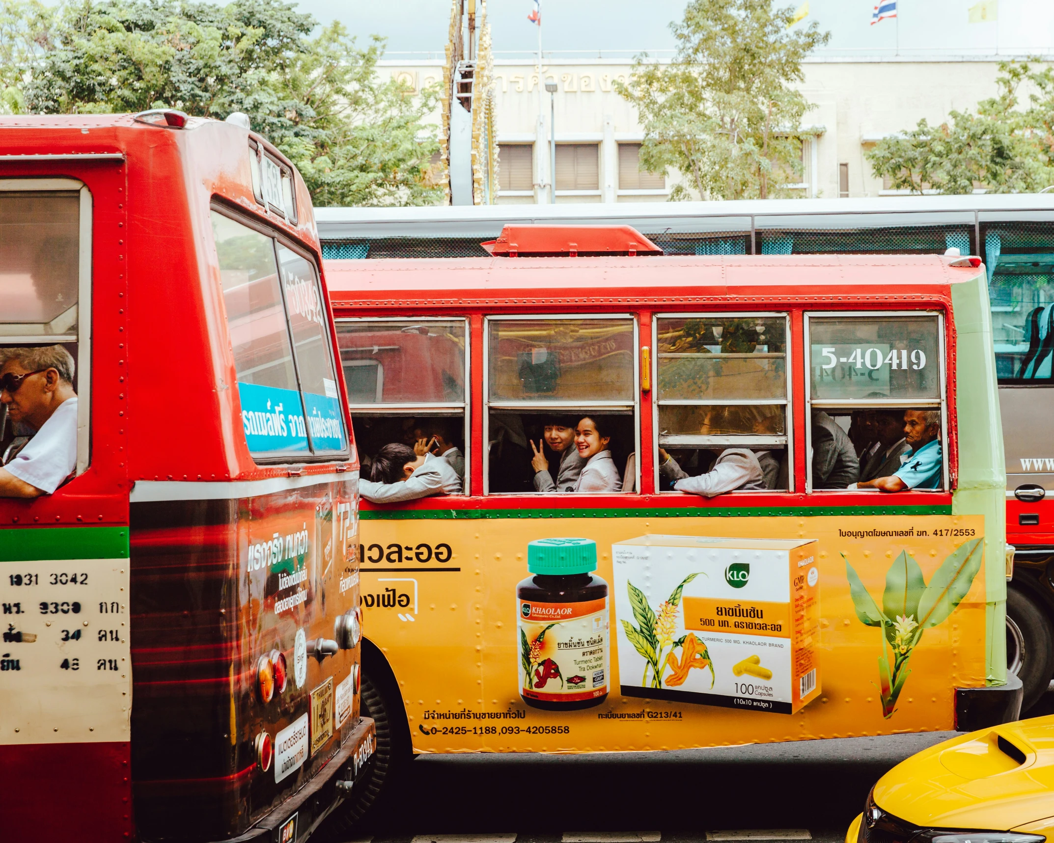 several busses are traveling next to each other