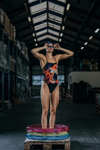 woman in swimsuit balancing on a colorful mat