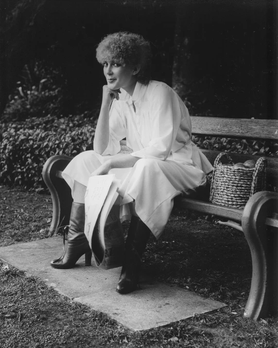 an old lady sitting on a bench with her chin resting under her chin