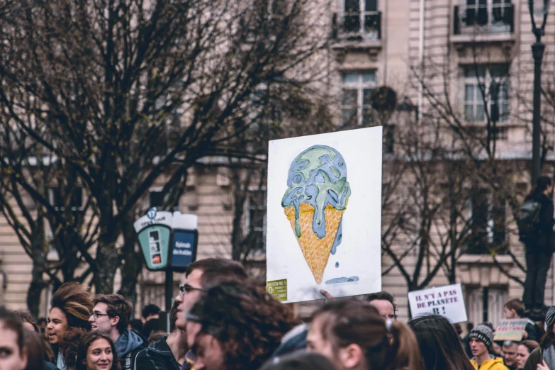 people outside in the crowd holding up signs