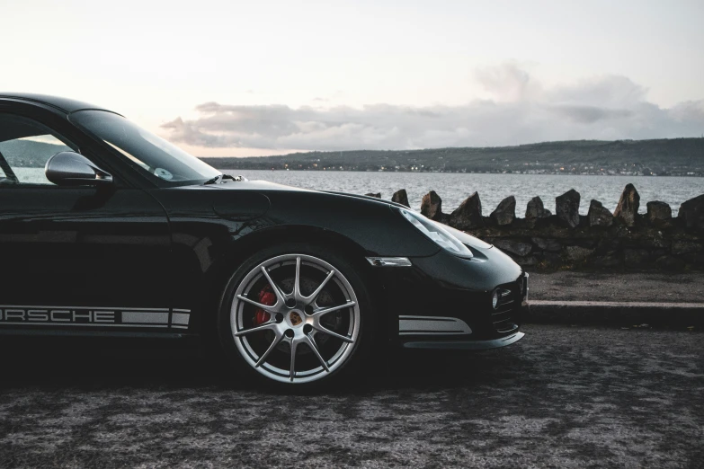 a car is parked in front of a body of water