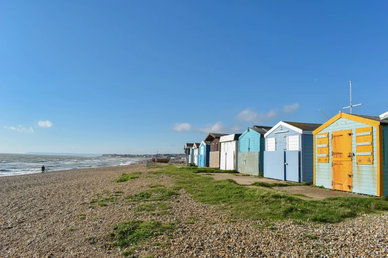 row of beach huts on a sunny day at the beach