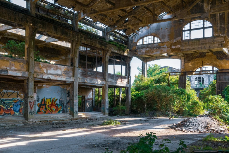 a dilapidated building has graffiti on the walls