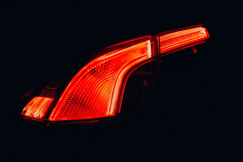 the tail lights of a car that is shining red