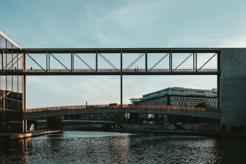 the underside of a bridge with metal rods extending over water