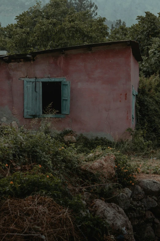 the red building has the door open in the field