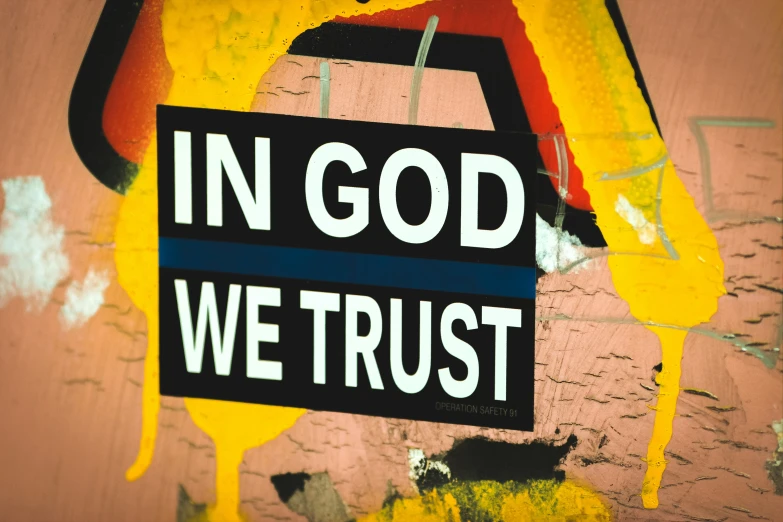 a sign on a wall that says in god we trust