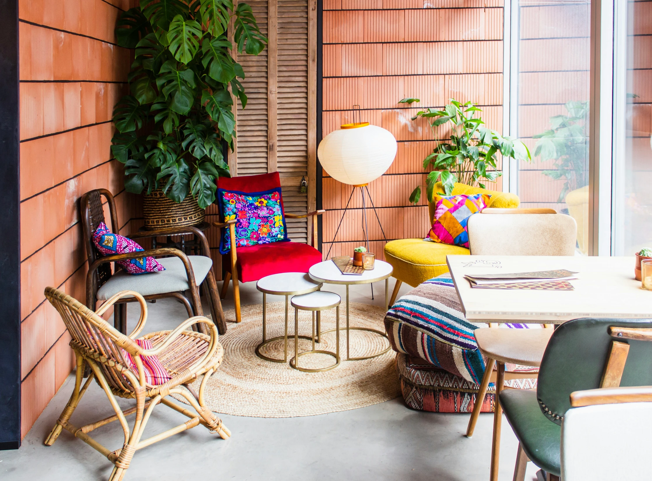 a room filled with colorful furniture next to a tall window