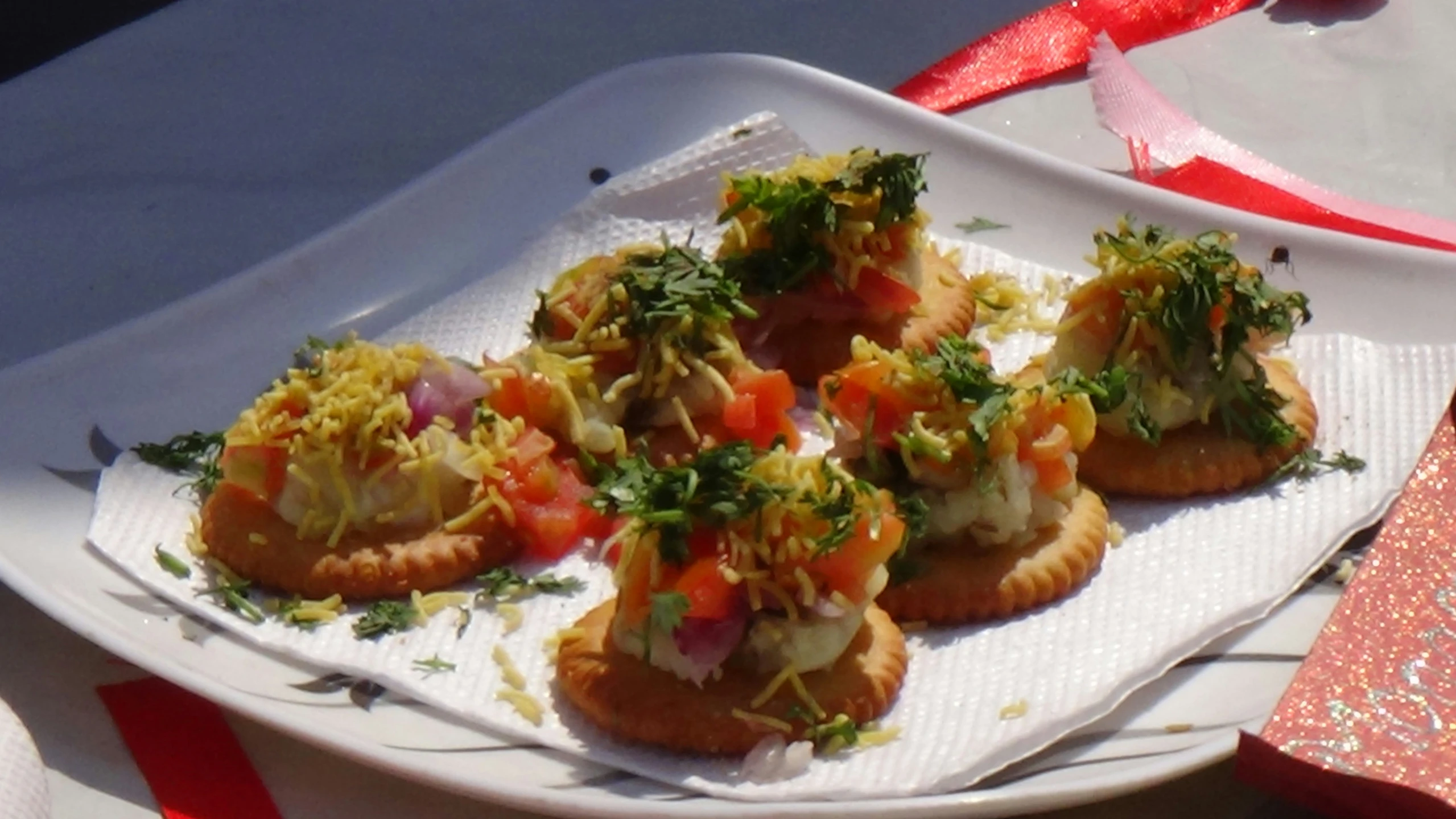 four appetizers are on a square white plate