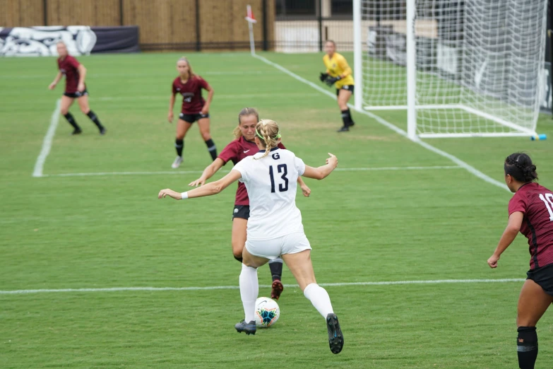 women soccer teams playing against each other on the field