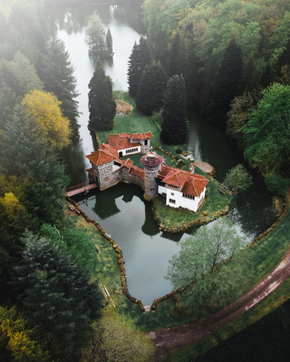 an aerial po of a house surrounded by green trees