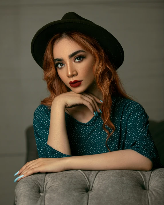 a woman is posing for a picture wearing a hat