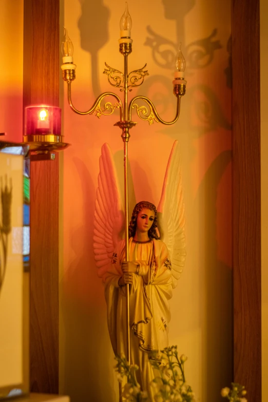 a small angel figurine on a metal rod