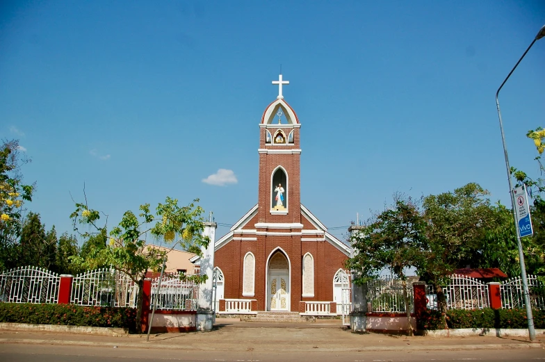 an old church with a white cross on top