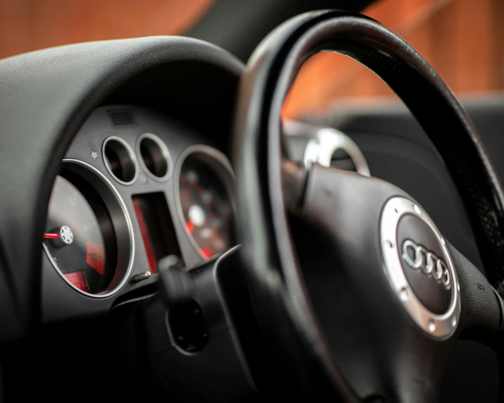 the steering wheel of a car with ons and a dashboard