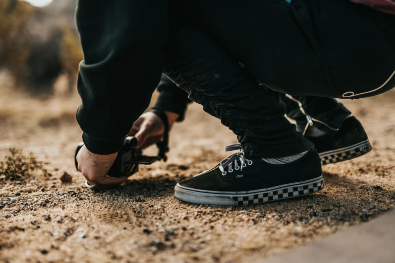 two legs in sneakers as they walk down the street