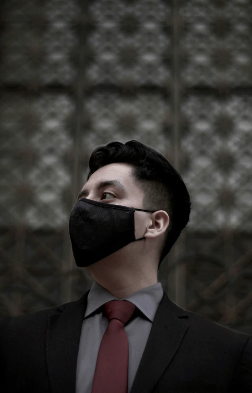 a man wearing a face mask with black mesh