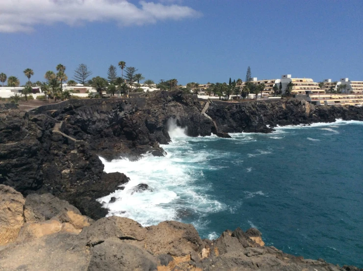 a scenic ocean scene with waves and cliffs