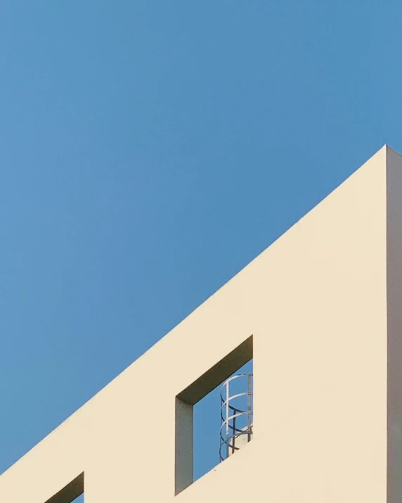 the small window has a bird perched on the roof